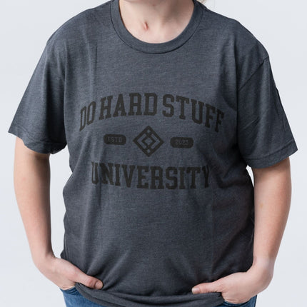 Casual side pose wearing the Do Hard Stuff Alma Mater t-shirt, relaxed fit