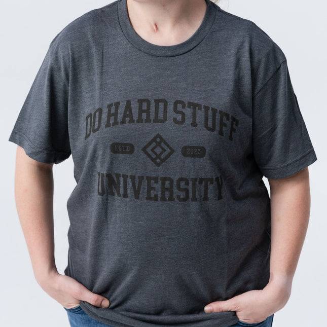 Casual side pose wearing the Do Hard Stuff Alma Mater t-shirt, relaxed fit