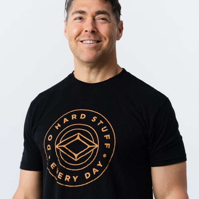 Front view of model wearing Do Hard Stuff Every Day tee with logo centered