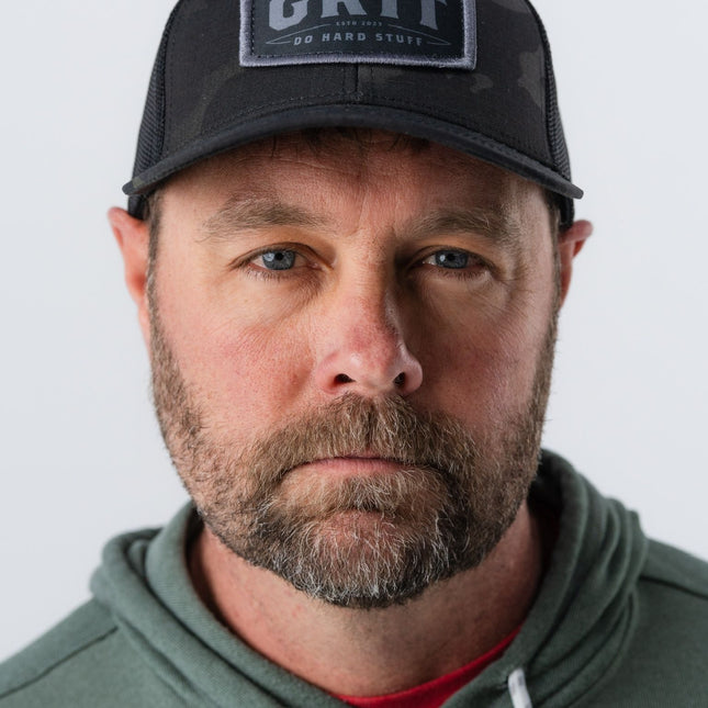 Close-up of man wearing Do Hard Stuff GRIT Hat in Magic Camo – motivational lifestyle hat for everyday strength