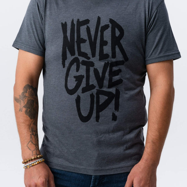 Man wearing dark gray Do Hard Stuff Never Give Up tee facing front