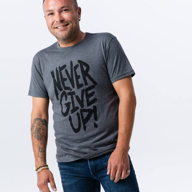 Full-body photo of man wearing Never Give Up tee from Do Hard Stuff
