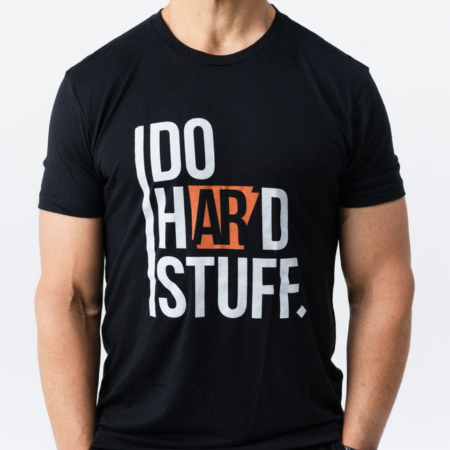 Front view of model wearing Do Hard Stuff Natural State Tee with Arkansas graphic