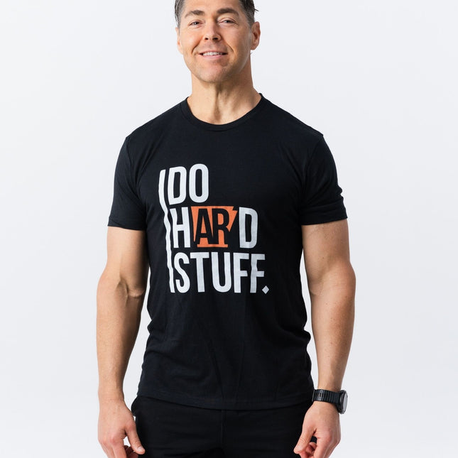 Model smiling while wearing Do Hard Stuff Natural State Tee in black