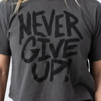 Closeup of Never Give Up crop tee in faded black print from Do Hard Stuff apparel line