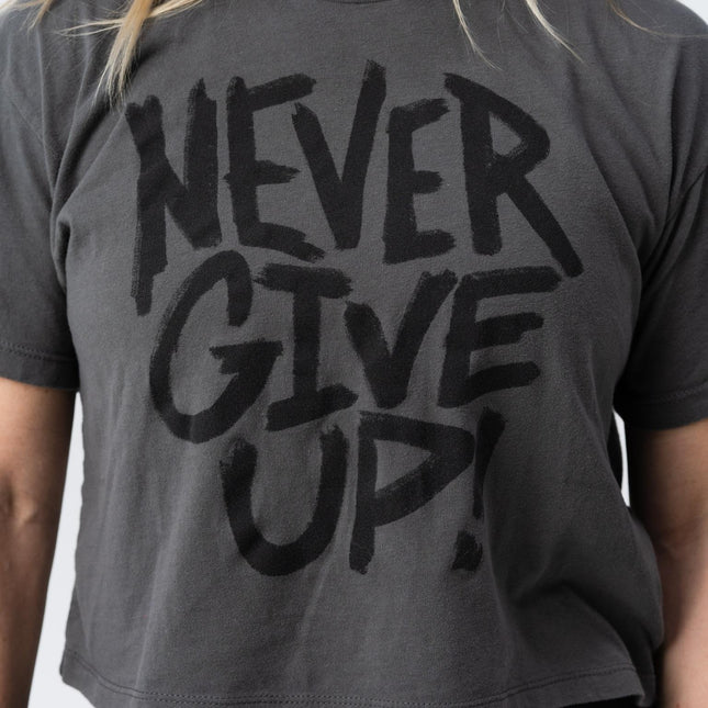 Closeup of Never Give Up crop tee in faded black print from Do Hard Stuff apparel line