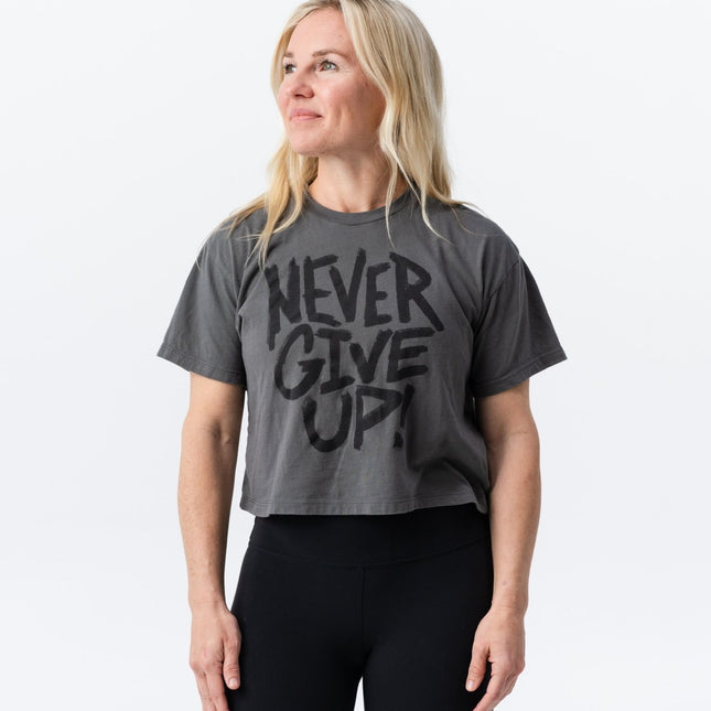 Side profile view of Do Hard Stuff Never Give Up crop tee worn by blonde model
