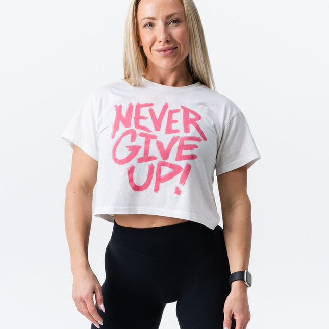 Front-facing view of athletic woman wearing the Do Hard Stuff pink and white crop tee.