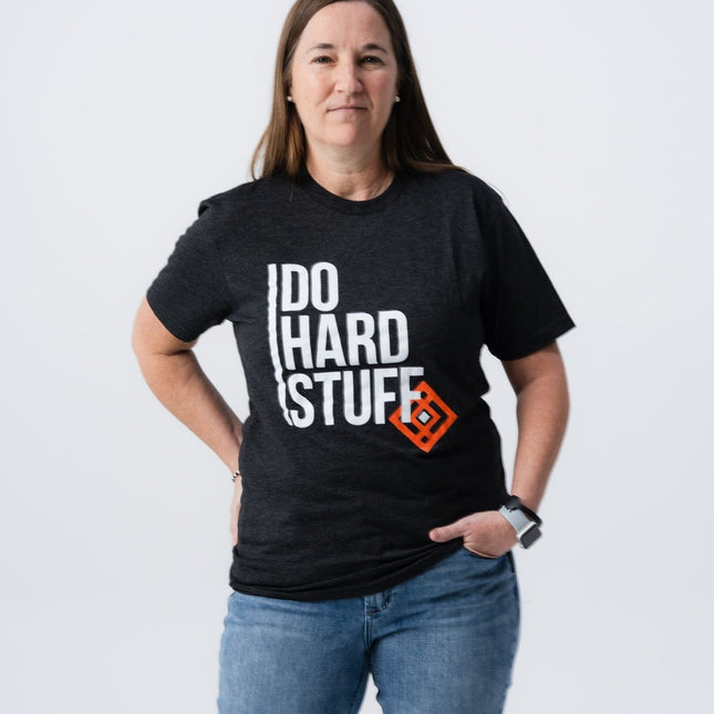 Woman smiling in Do Hard Stuff Mantra Tee with relaxed pose